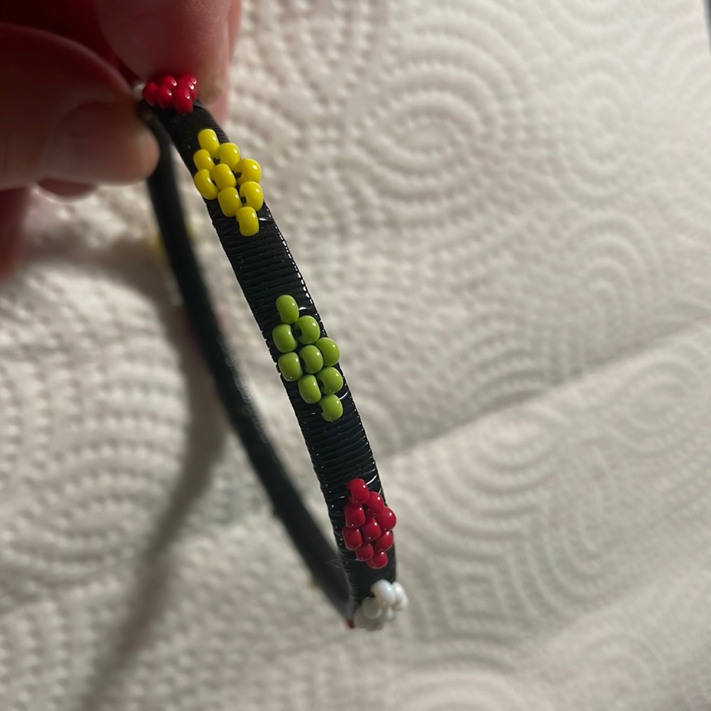 Seed bead bracelet with black band & white,yellow,red &light green beads. NWOT